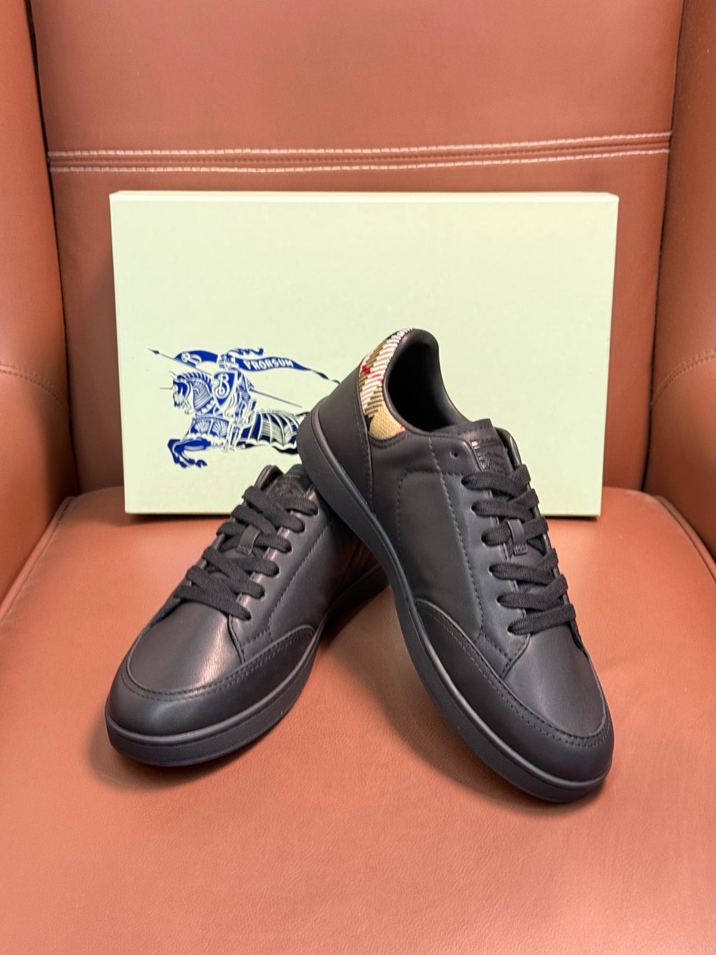 Dark leather lace-up sneakers with black laces and patterned collar lining