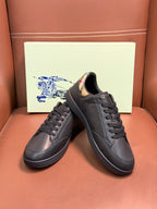 Dark leather lace-up sneakers with black laces and patterned collar lining