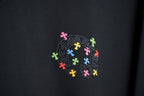 Black T-shirt with rhinestone-look circular multicolor cross-style graphic