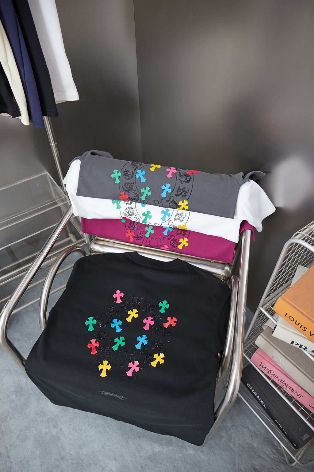 Black and gray short-sleeve T-shirts with multicolor cross-style graphics displayed