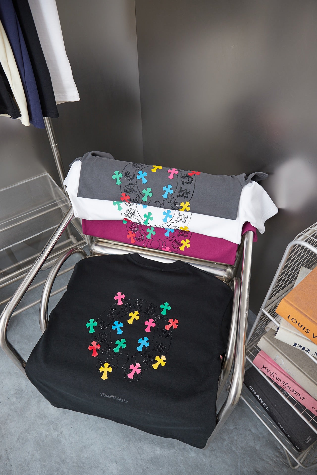 Black and gray short-sleeve T-shirts with multicolor cross-style graphics displayed
