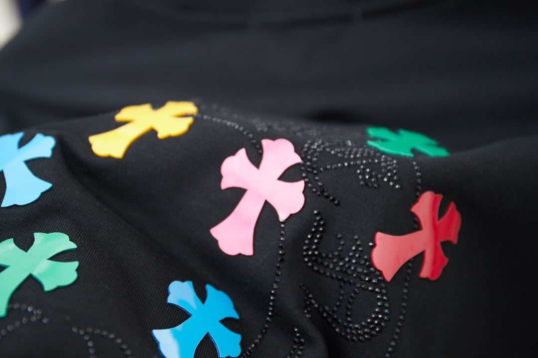 Close-up of black T-shirt rhinestone-look multicolor cross-style graphic
