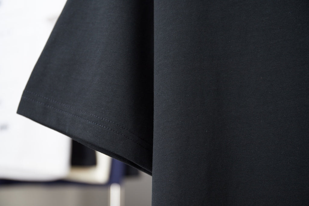 Black short-sleeve T-shirt with clean stitched side hem and curved bottom