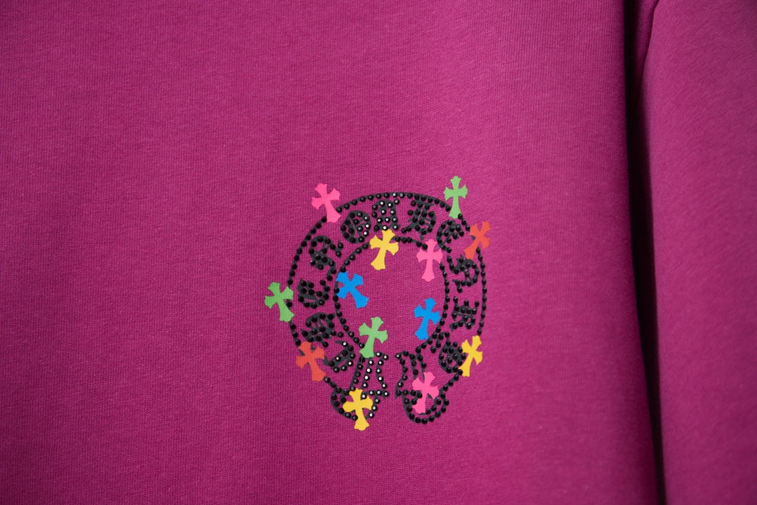 Purple T-shirt with small circular multicolor cross graphic on chest