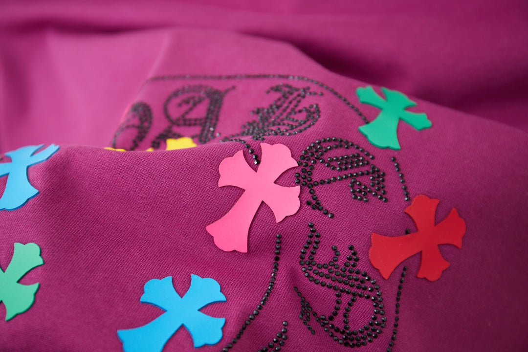Purple T-shirt fabric with close-up multicolor cross and swirl logo graphic