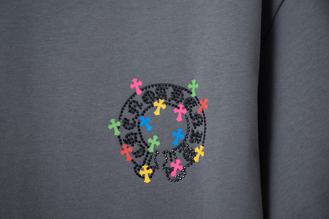 Gray T-shirt close-up of colorful cross emblem on chest