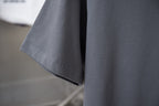 Gray T-shirt sleeve and hem with visible stitching detail
