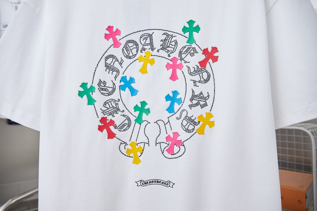 White graphic T-shirt with large circular multicolor cross print and small text