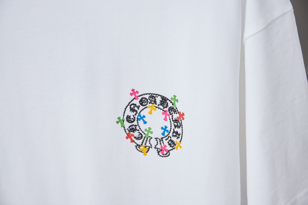 White graphic T-shirt with circular multicolor cross design on front