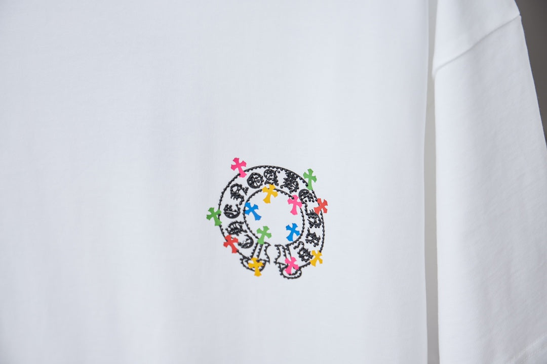 White graphic T-shirt with circular multicolor cross design on front