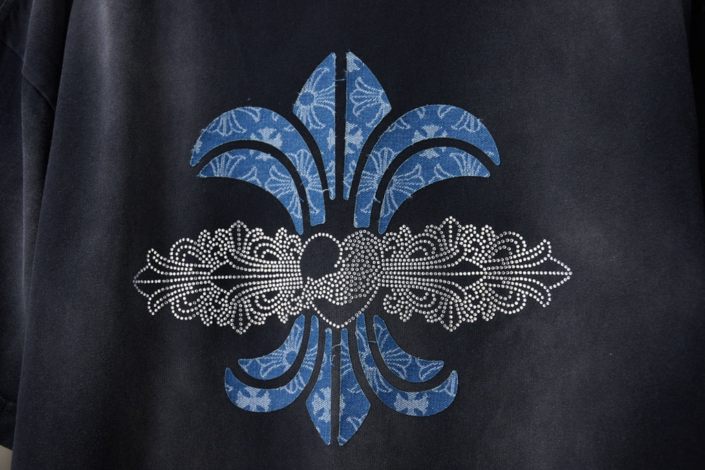Black T-shirt close-up of large fleur-de-lis graphic in blue and white