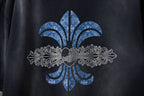 Black T-shirt close-up of large fleur-de-lis graphic in blue and white