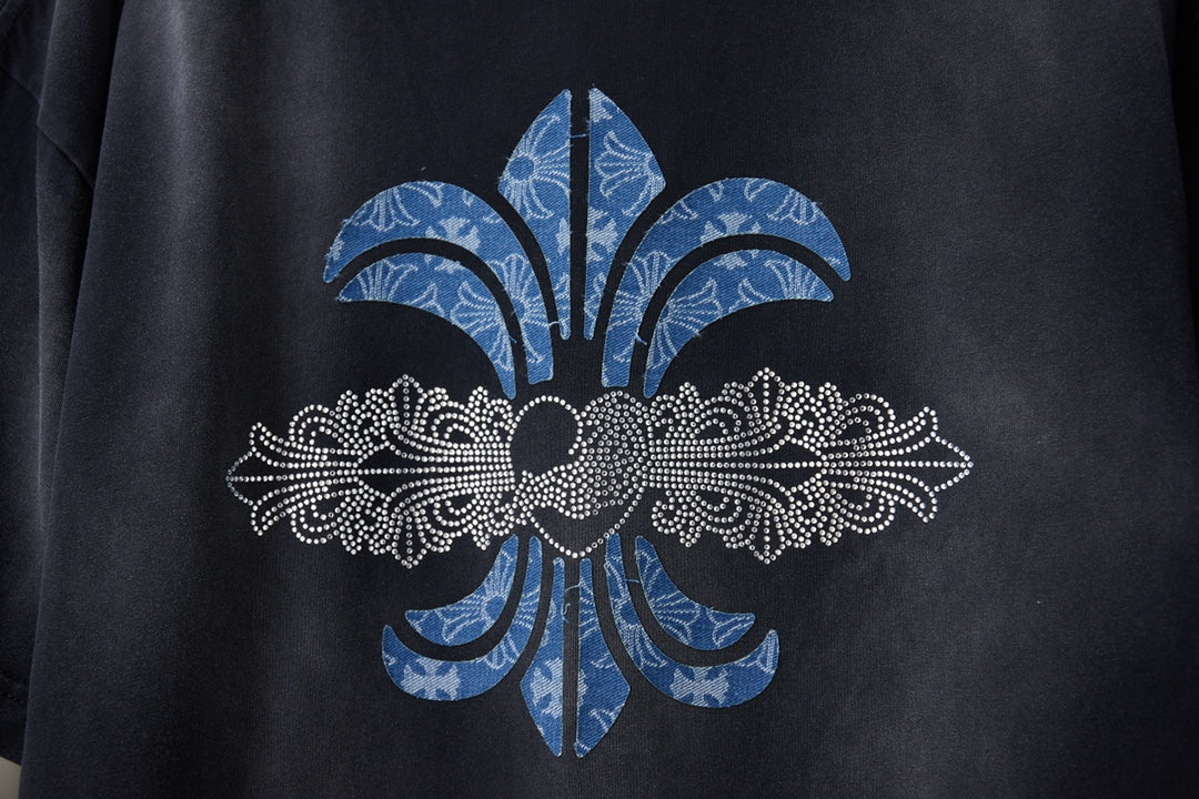 Black T-shirt close-up of large fleur-de-lis graphic in blue and white