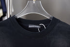 Black crewneck T-shirt collar with small interior logo label at neckline