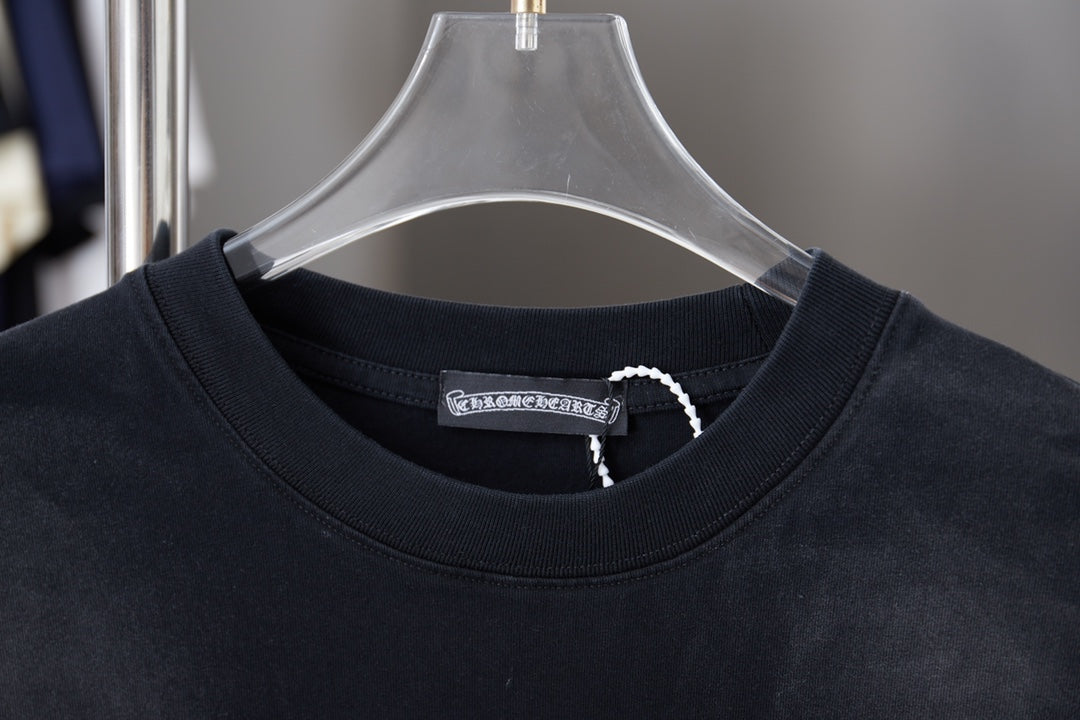 Black crewneck T-shirt collar with small interior logo label at neckline