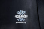 Black T-shirt with centered fleur-de-lis design in blue and white