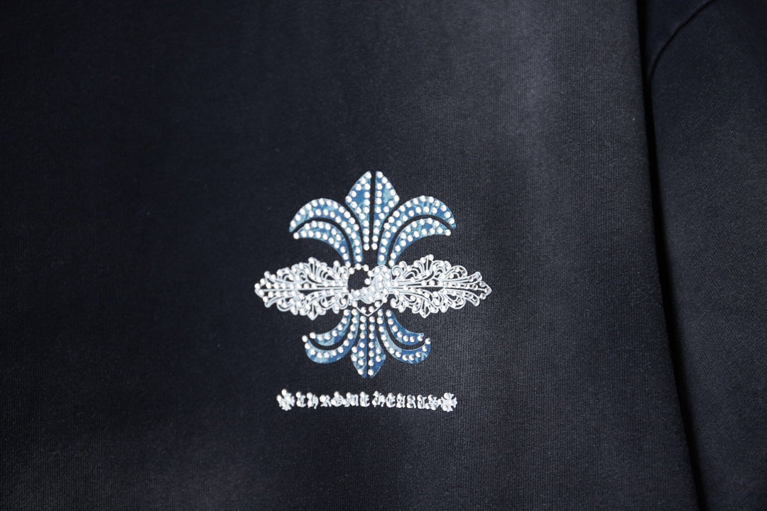 Black T-shirt with centered fleur-de-lis design in blue and white