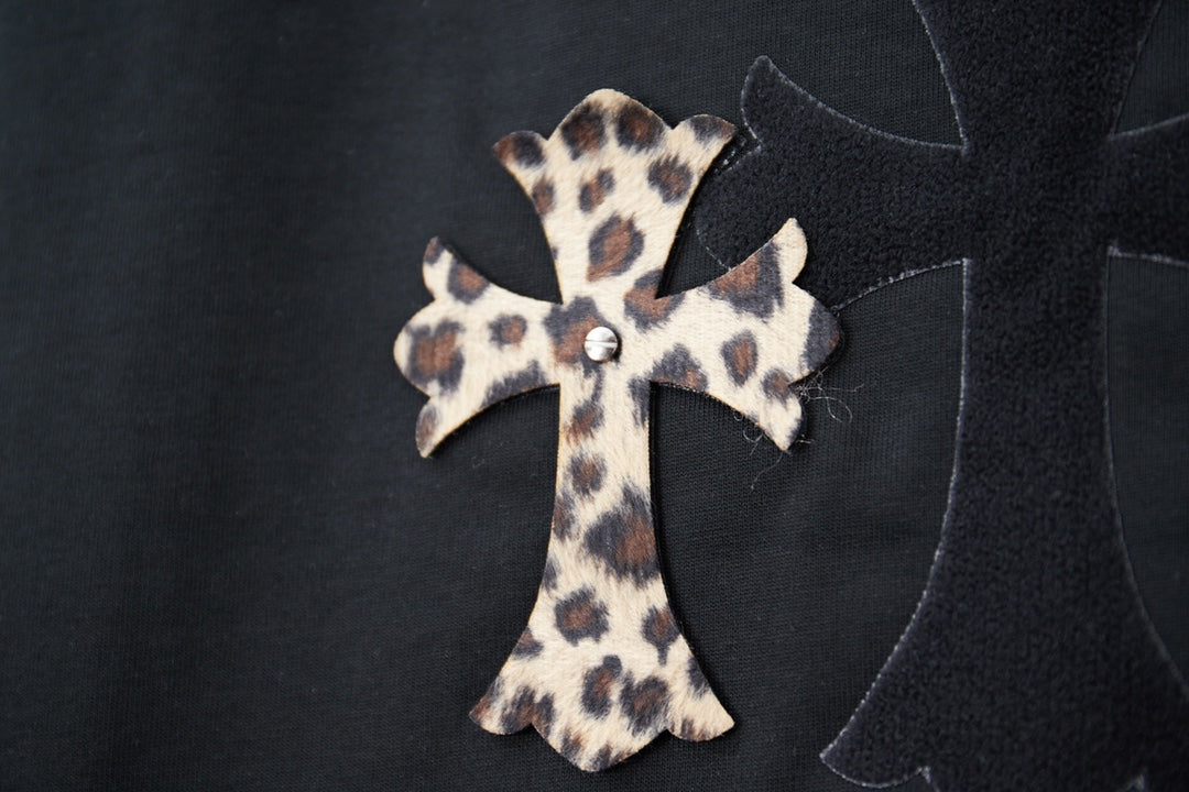 Black T-shirt with leopard-print cross applique and dark stitched outline