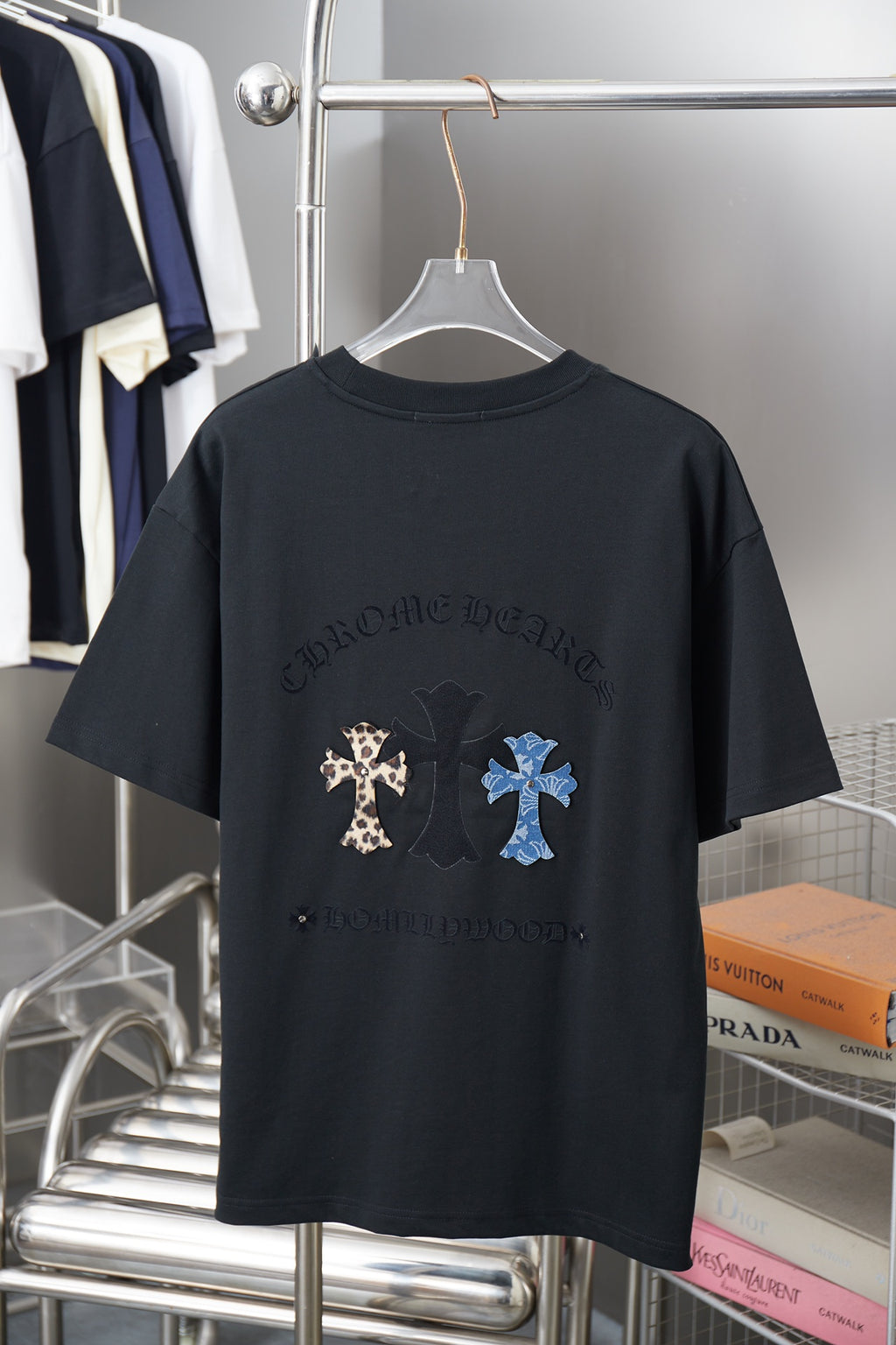 Black crew-neck T-shirt with back graphic text and multicolor cross patches