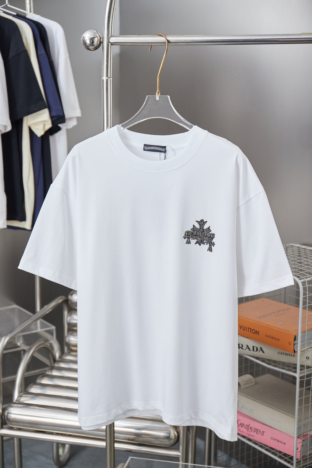 White short-sleeve T-shirt with dark star and cross graphic on the chest