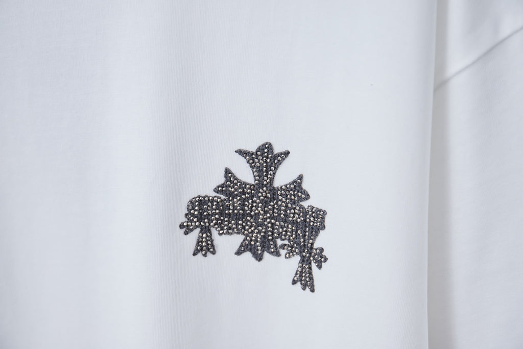 White short-sleeve T-shirt with dark embellished cross star graphic on chest