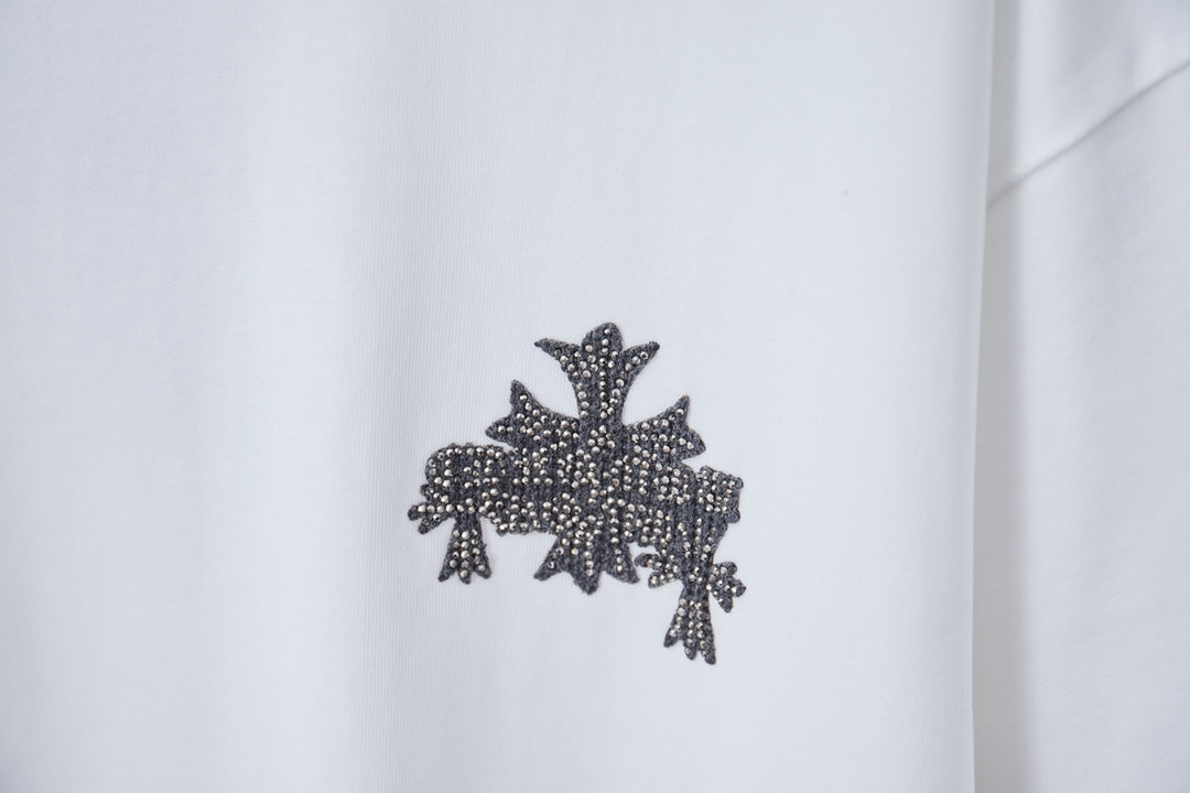 White short-sleeve T-shirt with dark embellished cross star graphic on chest