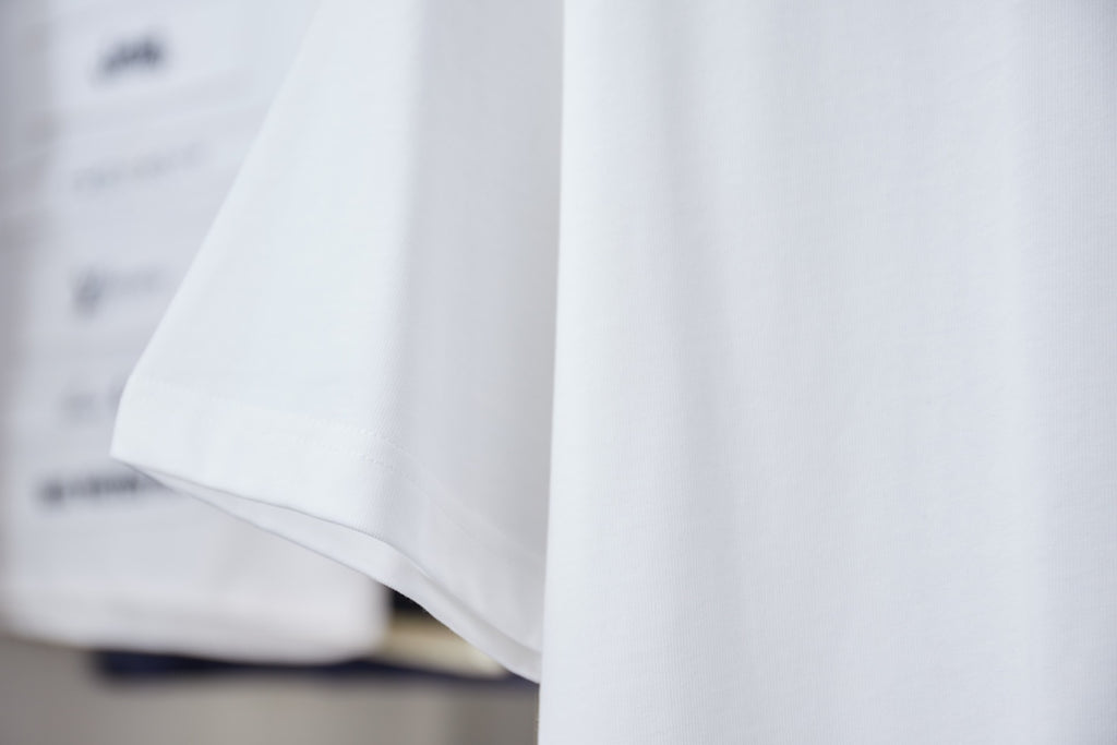 White short-sleeve T-shirt, side fold view, with clean hem and sleeve edge