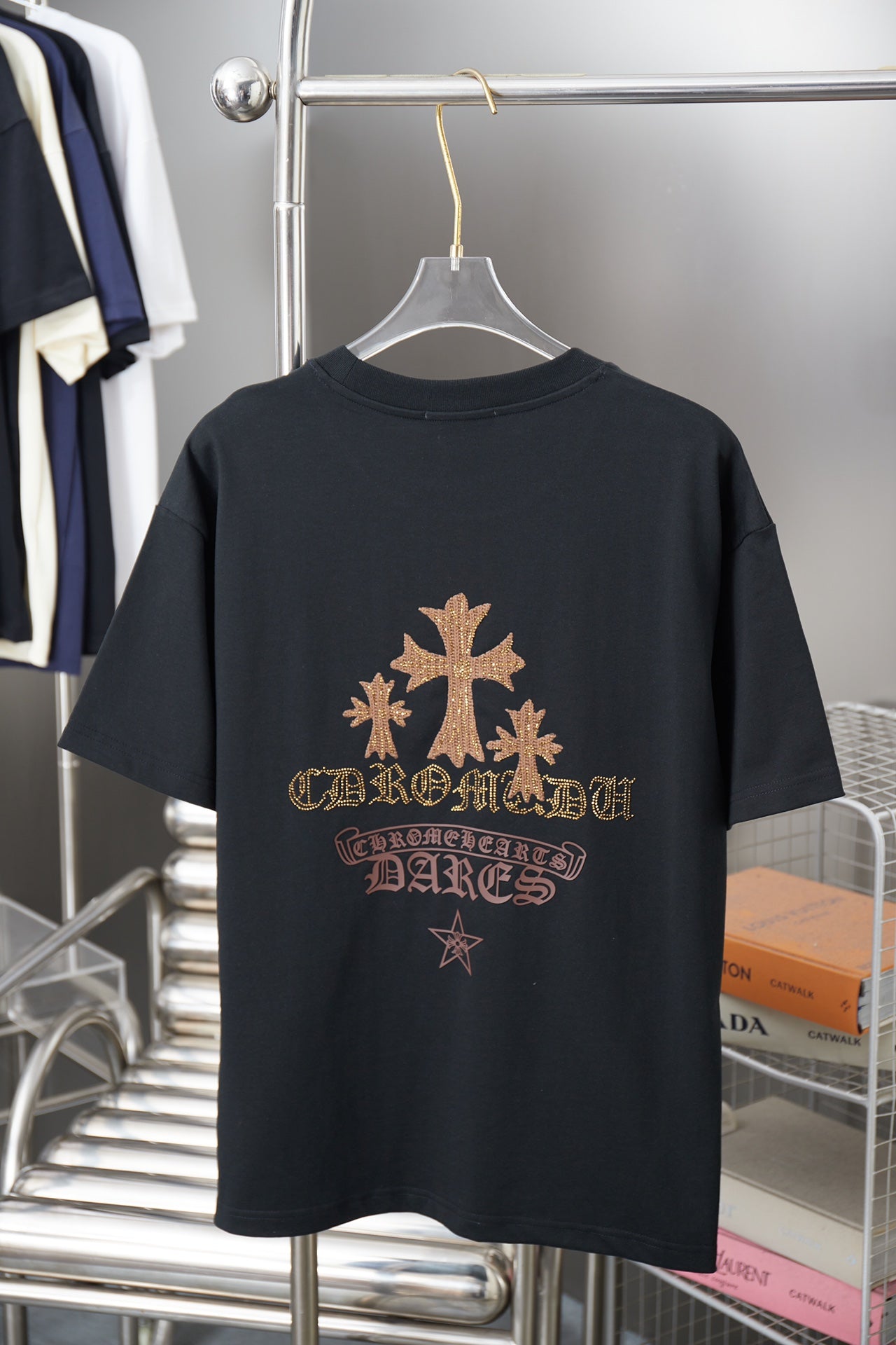 Graphic T-shirt back with large gold tree, star details, and ornate lettering