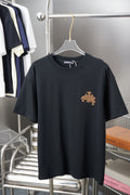 Graphic T-shirt in dark tone with small gold emblem and star on the chest