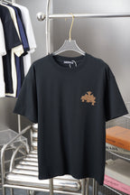 Graphic T-shirt in dark tone with small gold emblem and star on the chest