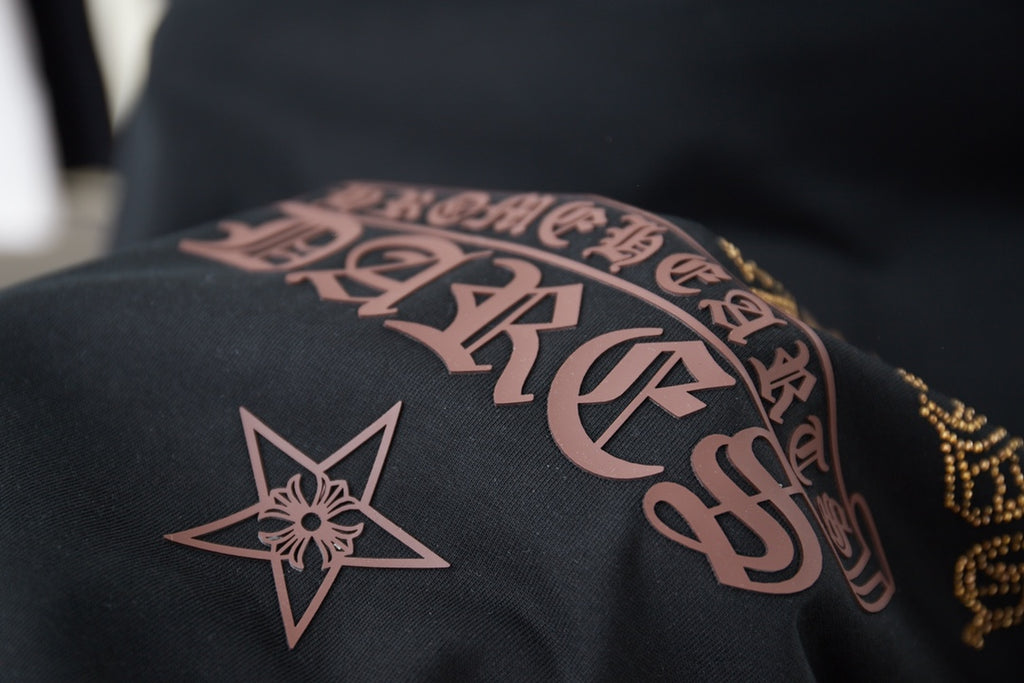 Graphic T-shirt sleeve with pink lettering and a star emblem