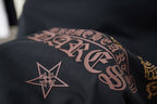 Graphic T-shirt sleeve with pink lettering and a star emblem