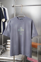 Crewneck short-sleeve T-shirt in dusty blue with small rhinestone crest on chest