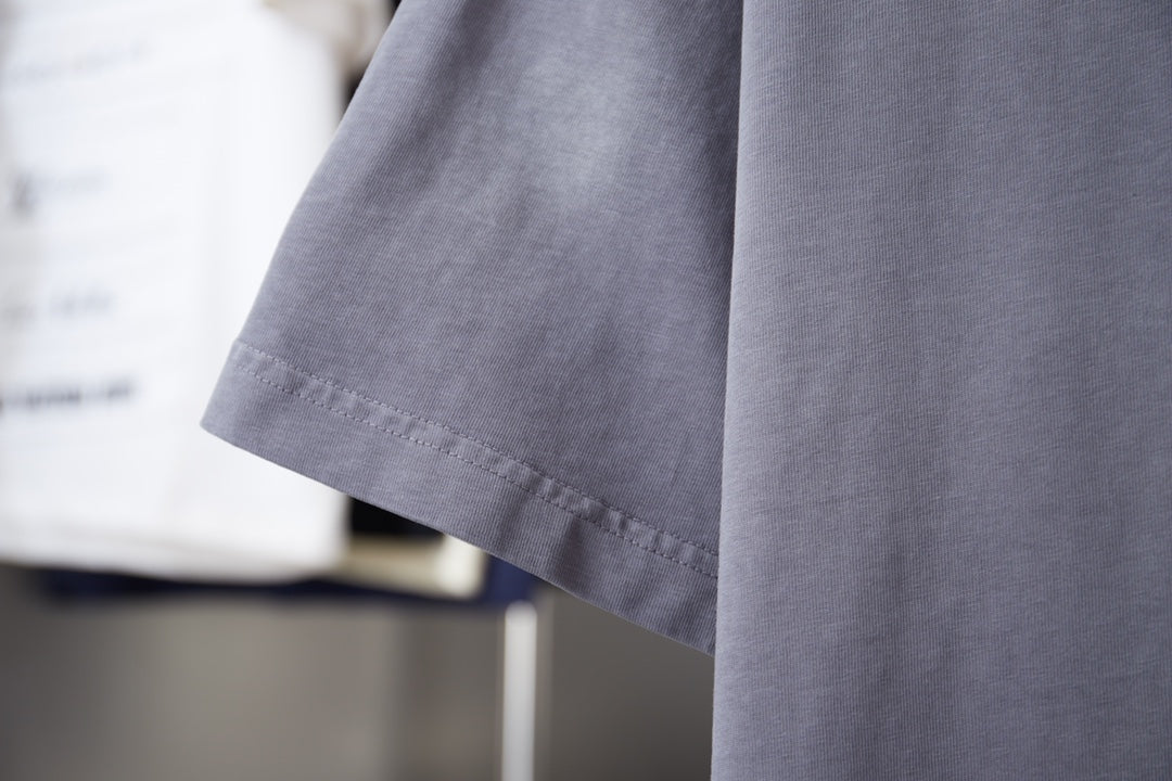 Dusty blue T-shirt sleeve and side hem detail in short-sleeve crewneck style