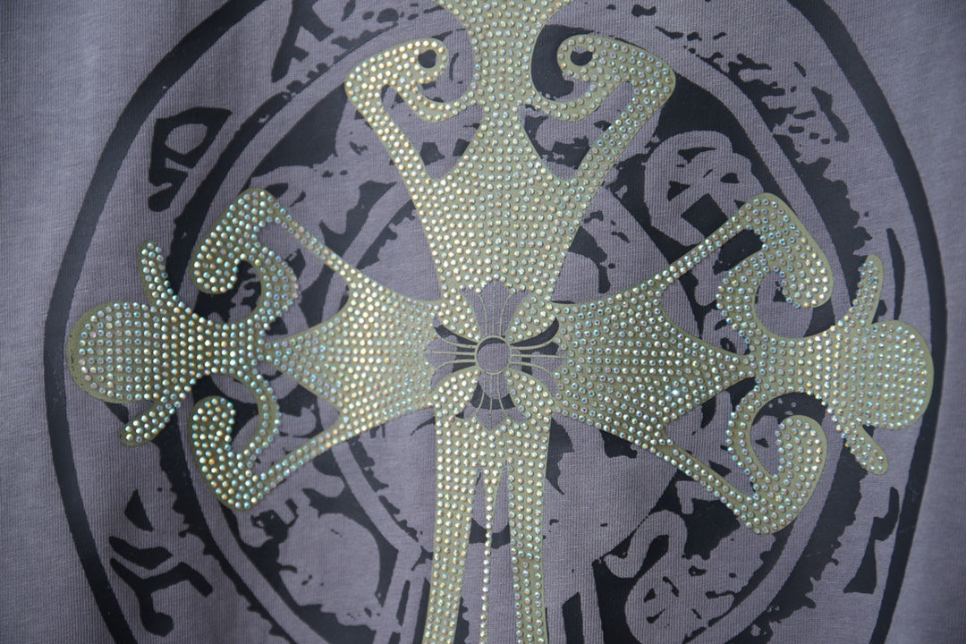 Dusty blue T-shirt front with large rhinestone circular emblem and ornate center