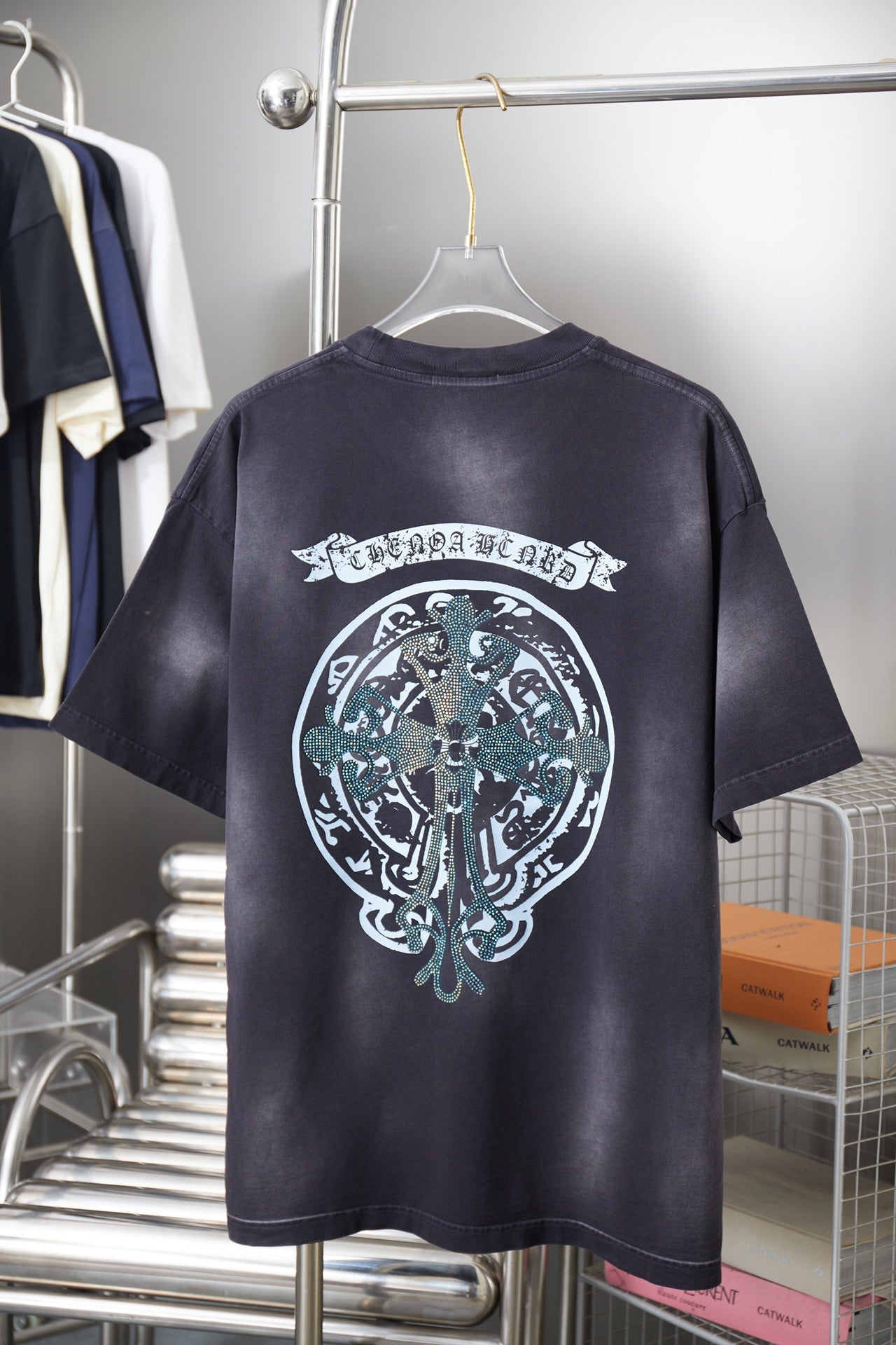 Dark navy short-sleeve T-shirt back with large circular emblem graphic in white