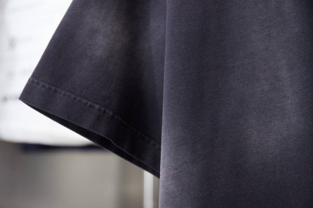 Dark navy T-shirt sleeve and hem with contrast-stitched edge