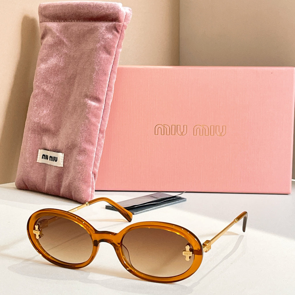 MiuMiu round sunglasses with tortoiseshell frames, gold accents, and amber lenses