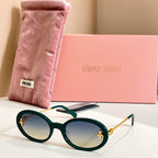 MiuMiu round sunglasses with dark green frames, gold accents, and dark lenses