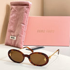 MiuMiu round sunglasses with dark tortoiseshell frames, gold accents, and brown lenses