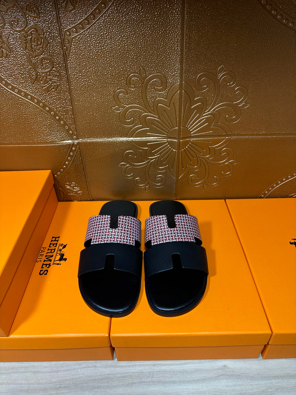 Hermes sandals with black slide sole and light patterned cross strap, open toe, pair