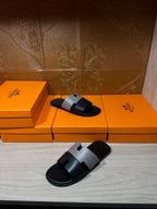 Hermes slide sandals, black slide with woven gray strap and buckle accents