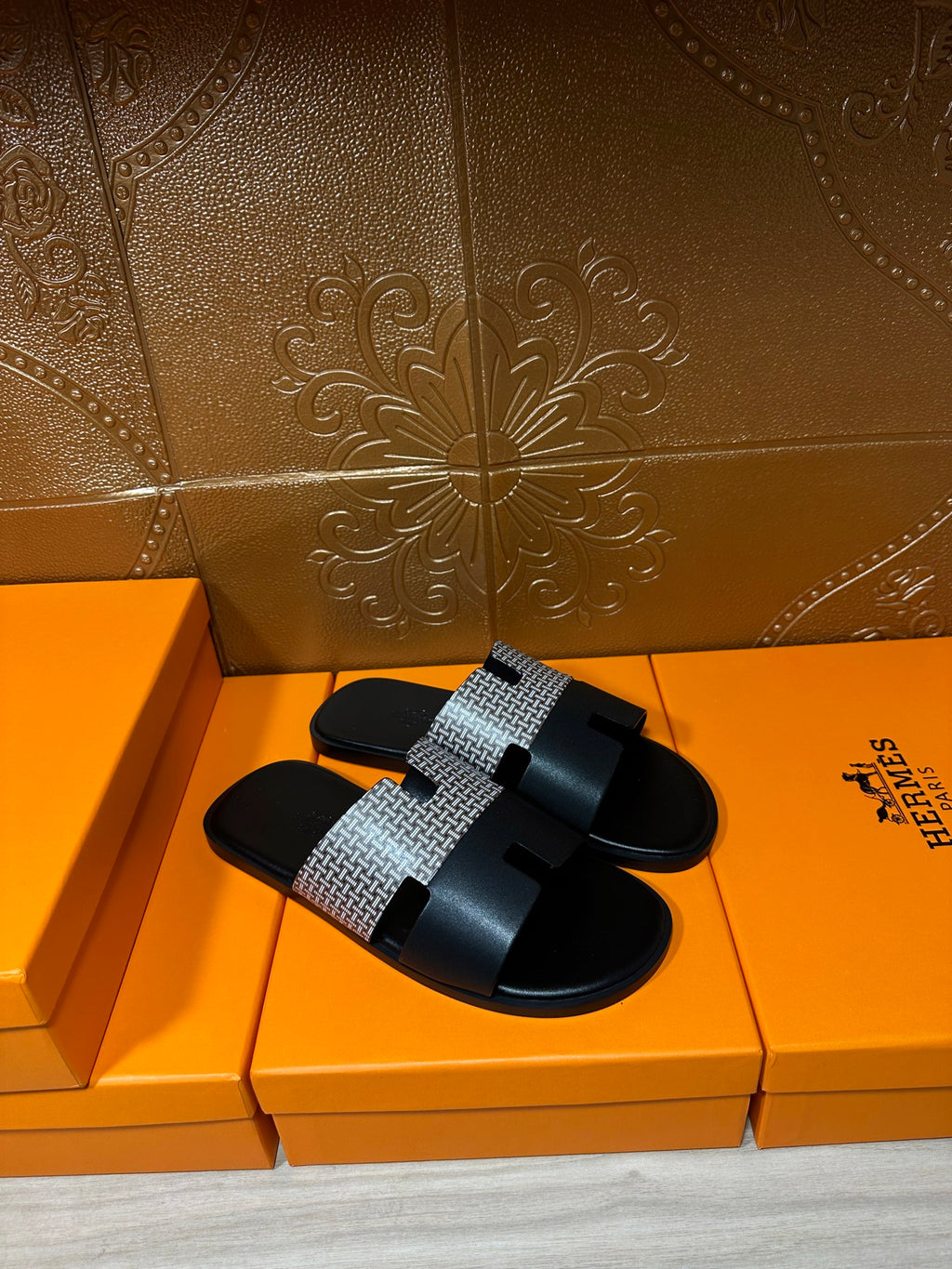 Hermes slide sandals with black sole and wide woven gray strap with black buckle detail