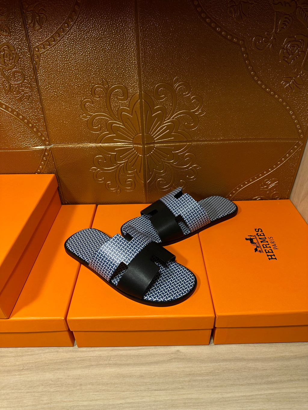 Blue woven slide sandals with black strap bands and buckle, pair front angle