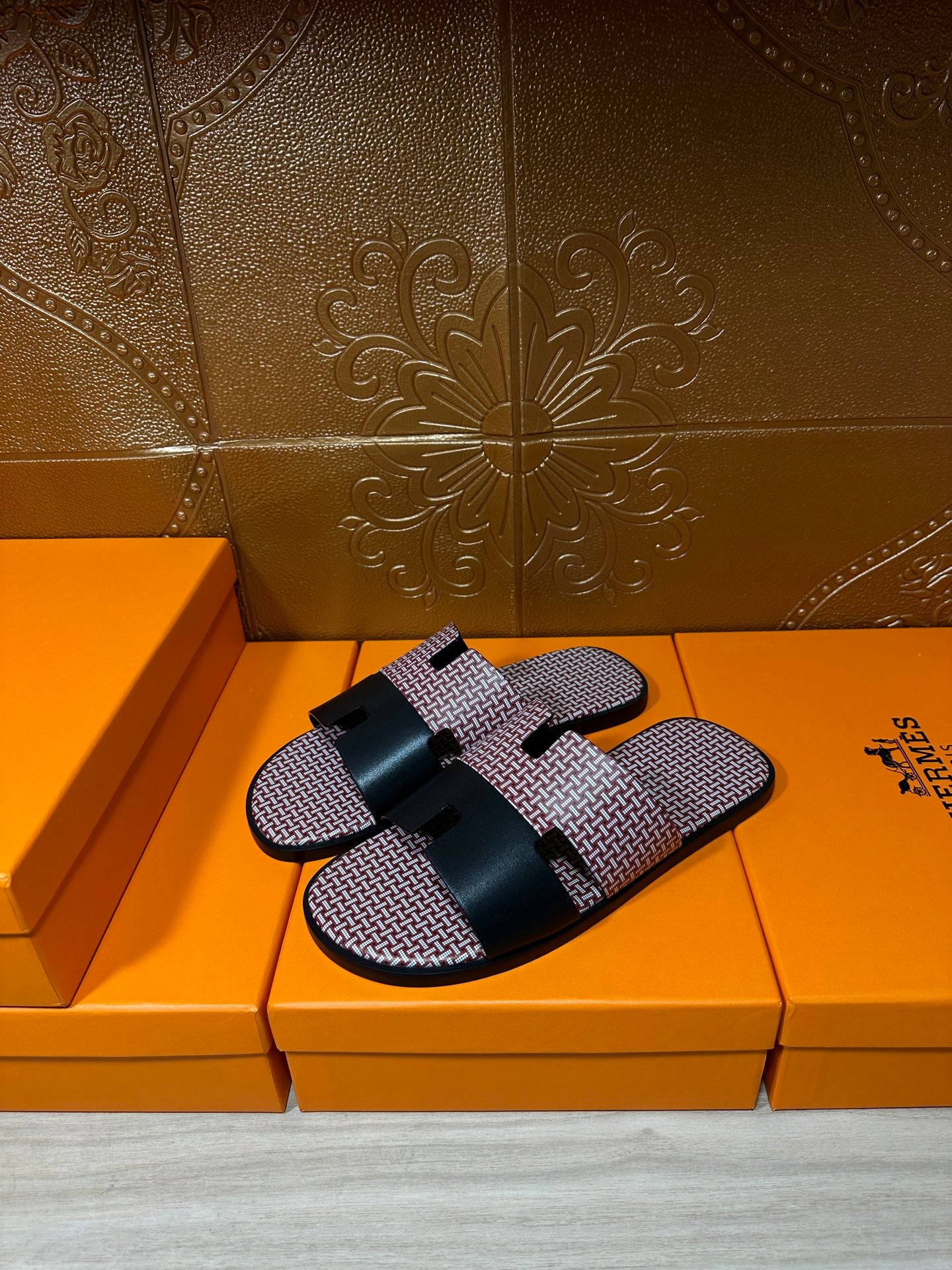 Slide sandals with pink textured fabric straps and black buckle detail; single shoe