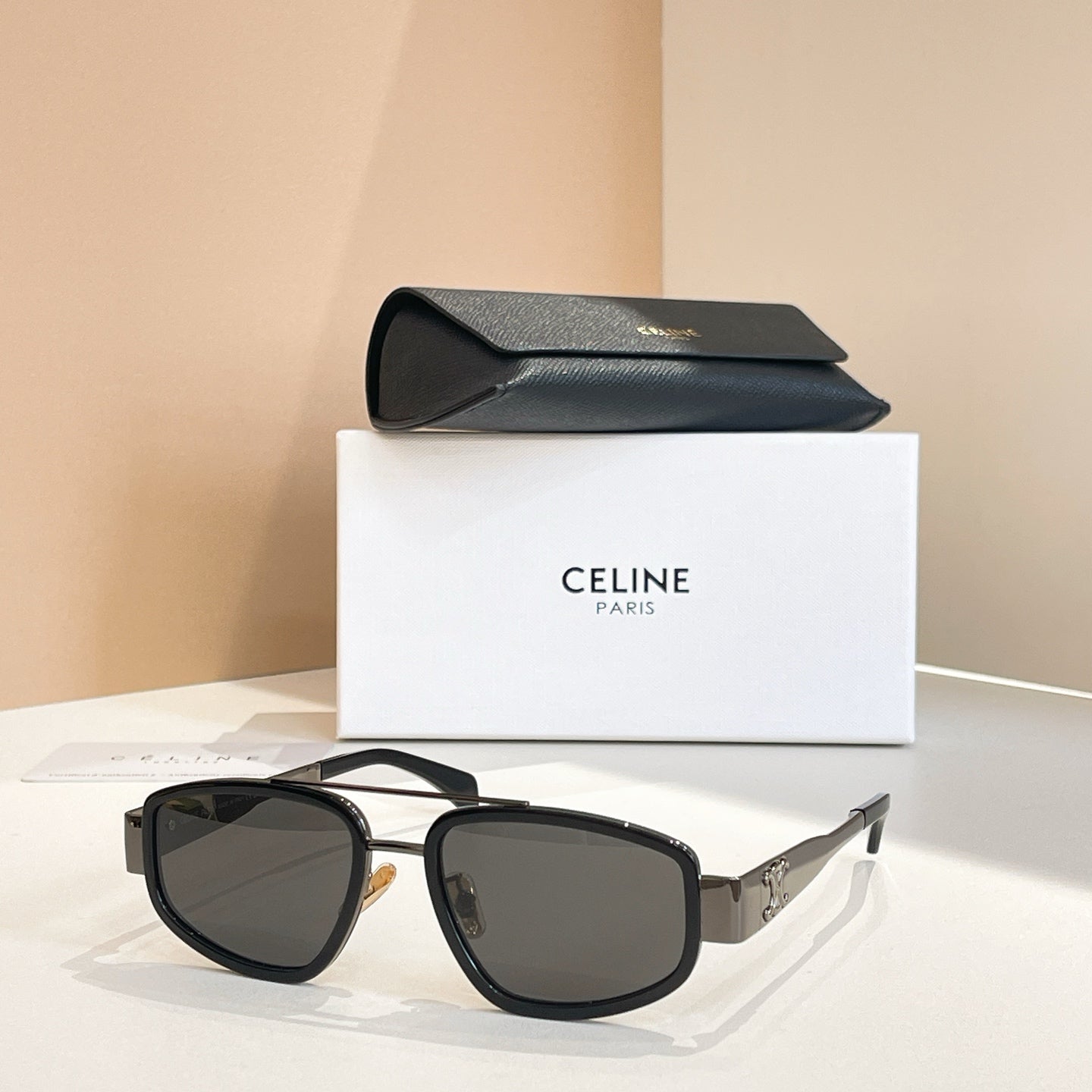 Celine sunglasses with dark frames and black lenses, gold-tone details