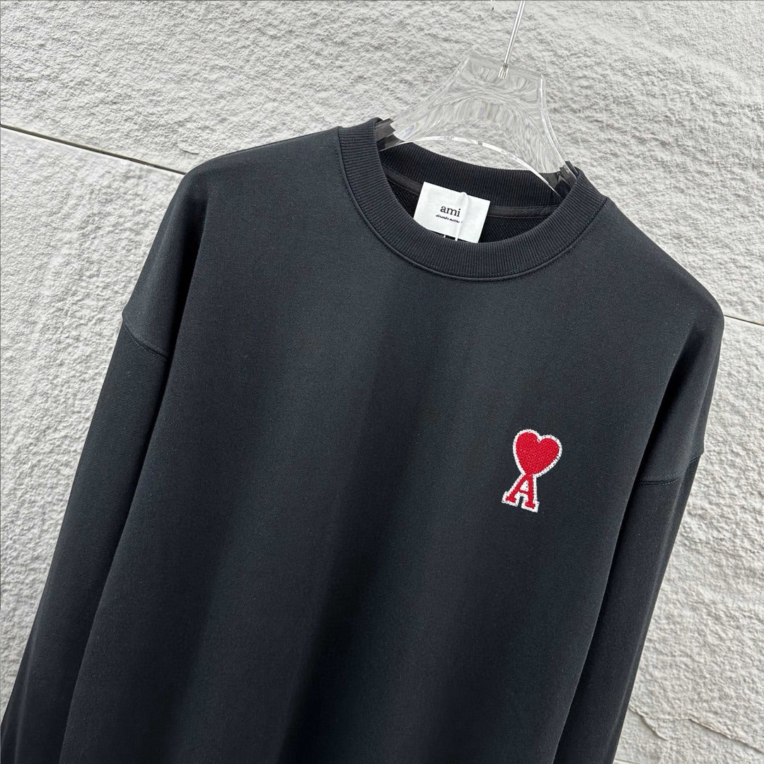 Amiri crewneck sweatshirt close-up, dark navy, red heart and A logo