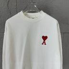 White crewneck sweatshirt front view with red heart and A logo