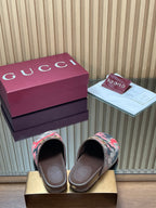 Gucci slide sandals, pink-and-black patterned canvas with gold-tone buckle, open toe view