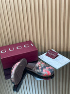 Gucci slide sandals, pink-and-black patterned strap and gold-tone buckle with sole view